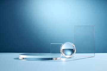 Front view of transparent podium glassware decorated in blue background with blank space