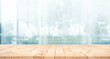 © hakinmhan - Selective focus.Top of wood  table with window glass and cityscape background.