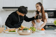 © sarayutsridee - Asian family have fun cooking at home together. Happy dad and mom with little daughter cooking together in kitchen house. Family activities concept.