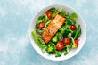 © Sea Wave - Grilled salmon fish fillet and fresh tomato vegetable salad with lettuce, arugula, broccoli and green beans. Healthy food, mediterranean diet
