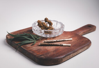 Rolled CBD medicinal marijuana and flower on wood background