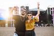 © maxbelchenko - Young and cheerful couple at music festival. Happy friends drinking beer and having fun at Beach party together. Summer holiday, vacation concept.