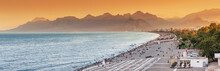 Sunset Panoramic View Of Scenic And Popular Konyaalti Beach In Antalya Resort Town. Majestic Mountains With Haze In The Background. Vacation And Holiday In Turkey