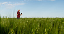 Farmer With Digital Tablet On A Field. Smart Farming And Digital Transformation In Agriculture.	Copy Space
