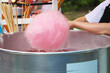 woman preparing pink cotton candy