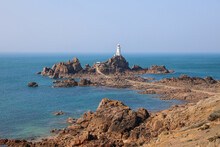 View Of The La Corbiere Lighthouse At Low Tide In Jersey