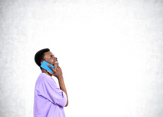 Poster - African American businessman wearing casual wear is talking on smartphone