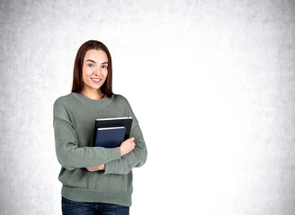 Wall Mural - Attractive businesswoman wearing casual wear is standing holding