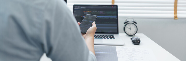 Wall Mural - software development concept, male programmer check website programming on smartphone and computer