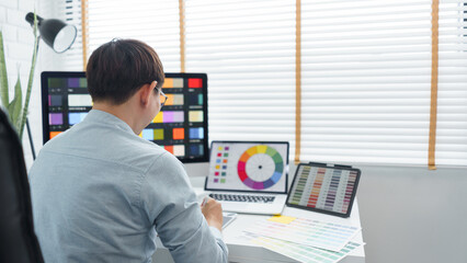 Wall Mural - creativity concept, male graphic designer using tablet and looking color swatch samples on screen