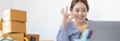 © Puwasit Inyavileart - Young Asian women are using laptop to record live chatting with customers, Use sign language Okay means OK, Order confirmation and online sales or sell online.