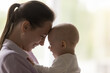 © fizkes - Childcare, babyhood, happy motherhood concept. Cheerful baby and young laughing mother touch foreheads, close up side profile view of faces, feeling love, enjoy gentleness and moments of tenderness