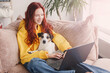 © Tatyana Gladskih - Relaxing young woman using laptop in living room