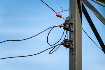 Electricity pole with pylon cable and conductor equipment with blue sky background.