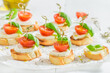 Delicious and healthy crostini with tomatoes, basil and mozzarella
