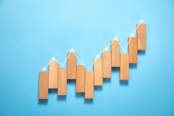 Wall Mural - Wooden blocks with a financial growth graph.