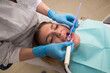 © Tania - Dentist-hygienist conducts a teeth cleaning procedure for a girl in a dental clinic. Removal of tartar.