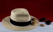Panama Hat With Sunglasses And Sea Shells On Red And White