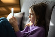 © irena_geo - Close up portrait of a Caucasian girl child looking at cell phone screen checking children content in social networks