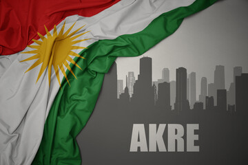 abstract silhouette of the city with text Akre near waving national flag of kurdistan on a gray background.3D illustration