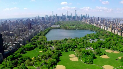 Fototapete - Aerial 4k video above green Central park in the middle of Manhattan, New York City during summer time. Beautiful New York city from above.