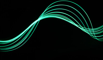 Wall Mural - Long exposure light painting photograph of neon colour fairy lights in an abstract swirl pattern against a black background