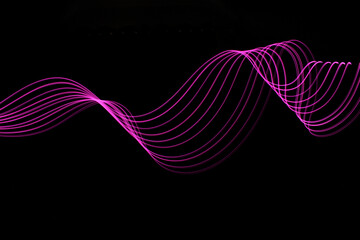 Wall Mural - Long exposure light painting photograph of neon colour fairy lights in an abstract swirl pattern against a black background