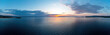 Sunrise over calm ocean aerial panorama. Sunset orange and blue color cloudy sky. Chalkidiki, Greece
