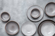 Handmade ceramics, empty gray craft plates. Gray grunge background. Top view, copy space