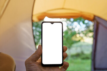 phone in hand in camping tent