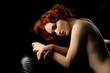 © Wisky - Alluring topless red haired woman on black couch