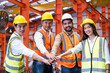 © BritCats Studio - Asian people group of multi mix race worker with supervisor holding hand to cheer up and encourage before working at industrial factory site. Teamwork, labor brainstorm or group working concept.