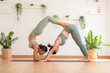 © 220 Selfmade studio - Couple and paired Asian young woman on yoga mat doing breathing exercise yoga Downward Facing dog and forearm stand together.Yoga meditation of two healthy female balancing body and relax at cozy home