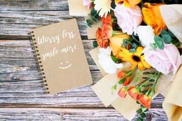 Wall Mural - Note pad with text Worry less smile more with mixed flower bouquet