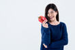 © Anatta_Tan - Portrait images of Asian attractive woman is good shape, holding and looking at a red vegetable, bell pepper, On white background, concept to weight loss woman and health care concept.