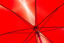Underside Of A Bright Colorful Red Umbrella In Sunlight