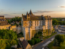 Sunset Aerial View Of Chateaudun  Castle In Eure-et-Loire In France With Imposing Circular Keep, Gothic High Chapel, Renaissance Residential Palace And Bell Tower Perched On A Limestone Outcrop