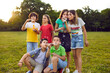 © Studio Romantic - Group children teens boys and girls posing on green lawn and blowing bubbles having fun with friends from elementary school dressed in casual clothes in summer park. Kids party outdoor concept