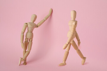 Wall Mural - Wooden human models in different poses on pink background