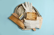 Beekeeping tools and uniform on light blue background, top view