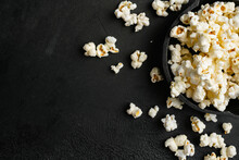 Tasty Salted Popcorn On Black Dark Stone Table Background, Top View Flat Lay, With Copy Space For Text