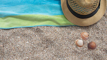 Yellow Straw Hat Towel Shade Of Blue And Green Colors On White Sand
