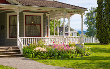 Entrance to a home through a beautiful garden with colorful flowers. Plants and flowers in in a garden