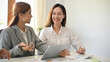 © bongkarn - Pretty young Asian businesswomen or female office workers working together