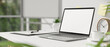 Close-up, Modern white office desk with portable notebook laptop and office accessories.