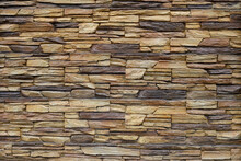 Stonewall Texture. Wall Of Flat Rough Yellow Stones. Rock Wall Background