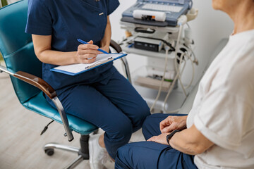 Wall Mural - Close up of doctor ultrasound specialist makes notes during patient appointment in clinic
