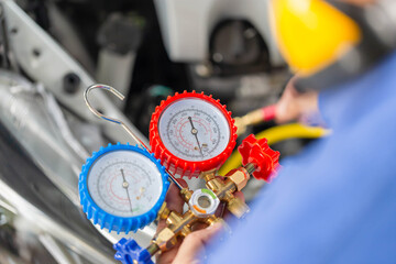 Repairman holding monitor tool to check and fixed car air conditioner system, Technician check car air conditioning system refrigerant recharge, Air Conditioning Repair