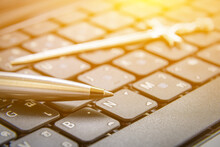 The Pen Is Mightier Than The Sword Concept : Ballpoint Pen And A Sword On A Laptop. This Proverb Or Phrase Is A Metonymic Adage, Indicating That A Journalist Can Report Lie Or Truth Using Only A Pen.