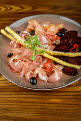 Wall Mural - jamon and bastrum beer appetizer in a plate, macro photo